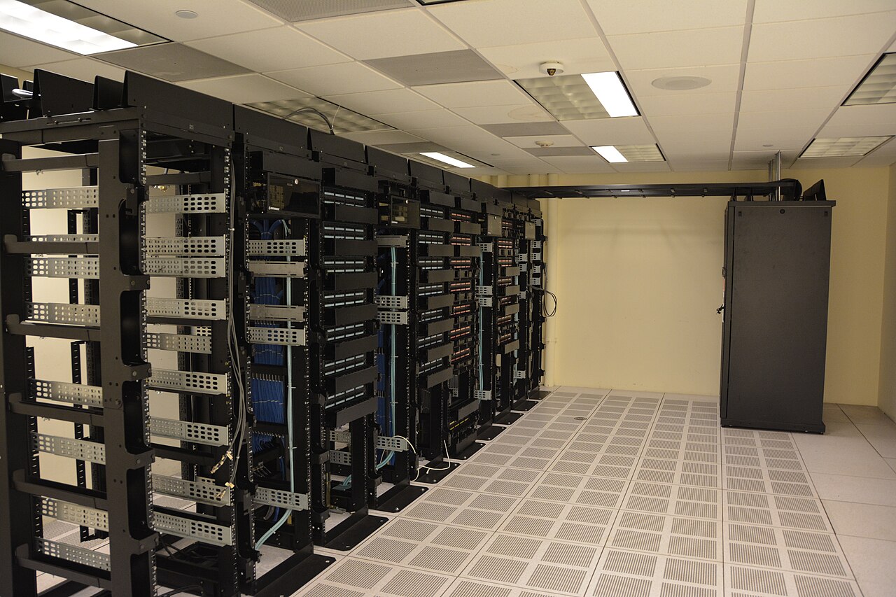 Rows of server racks inside a data center hall