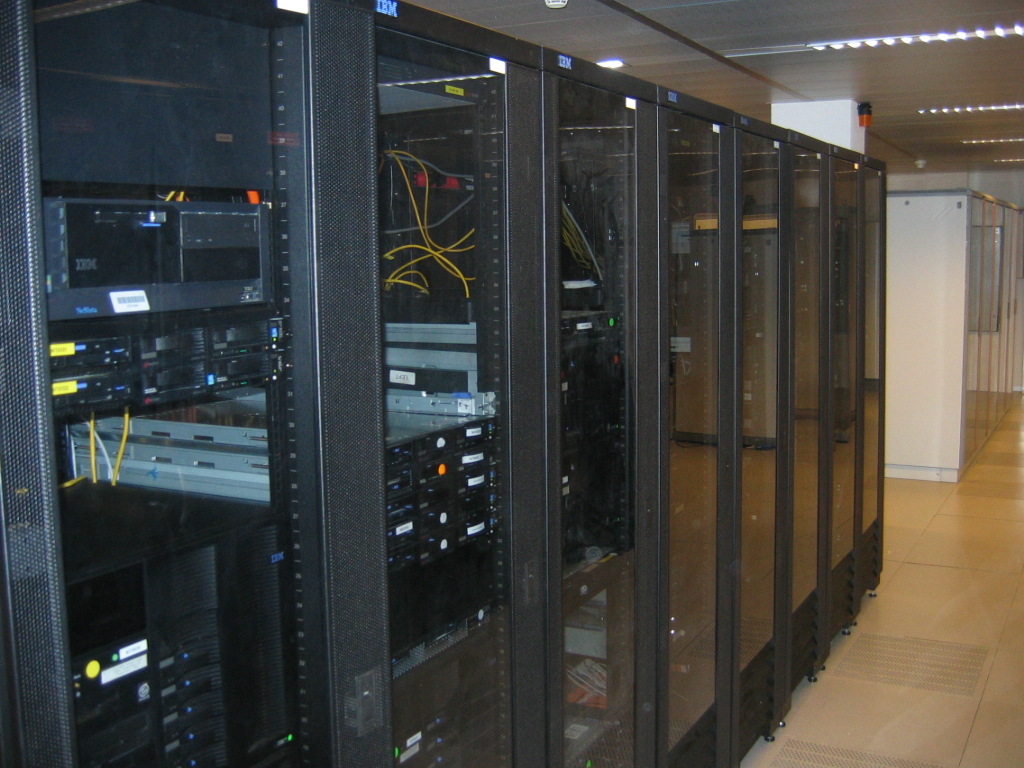 Rows of server racks in a data center, the kind of compute capacity SpaceX now leases from its Colossus cluster